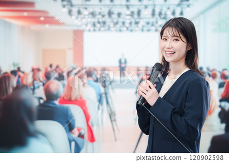 A female reporter asking a question at a press conference A female reporter asking a question at a press conference 120902598