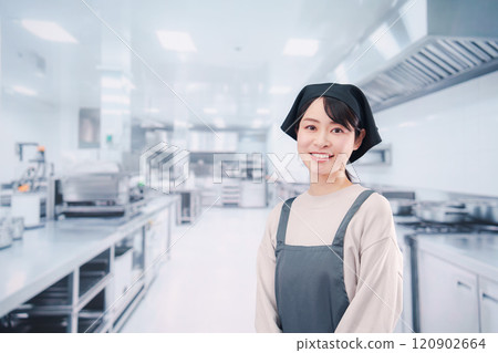 A female chef working in the kitchen A female chef working in the kitchen 120902664