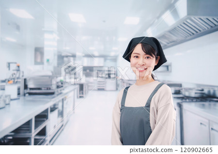 A female chef working in the kitchen A female chef working in the kitchen 120902665