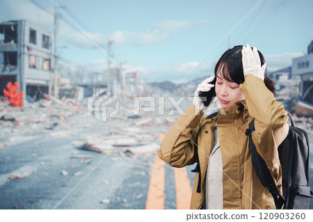 A woman who was affected by a disaster and is evacuating A woman who was affected by a disaster and is evacuating 120903260