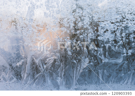 Frosty pattern on the window blue background. Frozen window glass. Frosty pattern on the window blue background. Frozen window glass. 120903393
