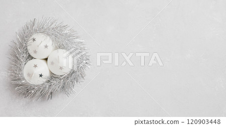Christmas decorations candles in silver tinsel on gray background with copy space. New Year. View from above. Space for text. Christmas decorations candles in silver tinsel on gray background with copy space. New Year. View from above. Space for text. 120903448