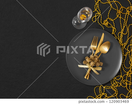 Christmas gold table setting on black background. New Year serving for a festive dinner. Top view, flat lay. Copy space. Christmas gold table setting on black background. New Year serving for a festive dinner. Top view, flat lay. Copy space. 120903469