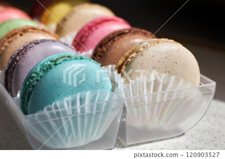Bright colorful cakes French Macarons with white paperpan in plastic box 120903527