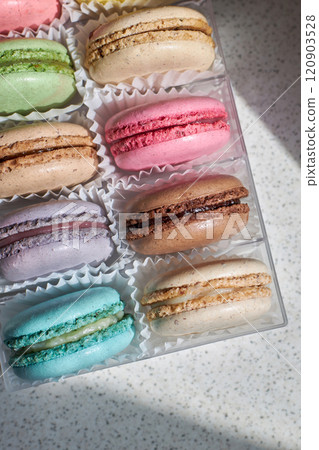 Bright colorful cakes French Macarons with white paperpan in plastic box 120903528