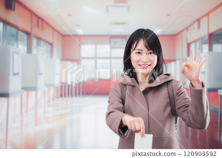 Female voter casting her vote at a polling station 120903592