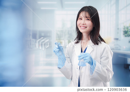 A female researcher conducting research in a laboratory A female researcher conducting research in a laboratory 120903636