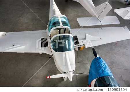 Top view of small sports airplanes in a hangar 120905594