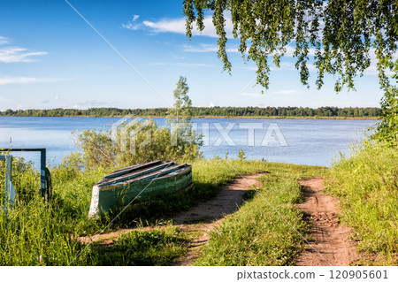 Old boat on the river bank 120905601