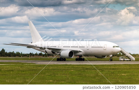 Wide body passenger airplane with boarding stairs at the airport apron Wide body passenger airplane with boarding stairs at the airport apron 120905850