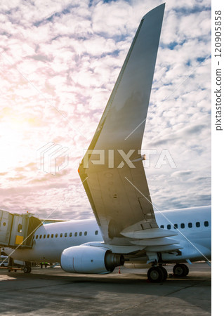 White passenger aircraft parked to a jetway White passenger aircraft parked to a jetway 120905858