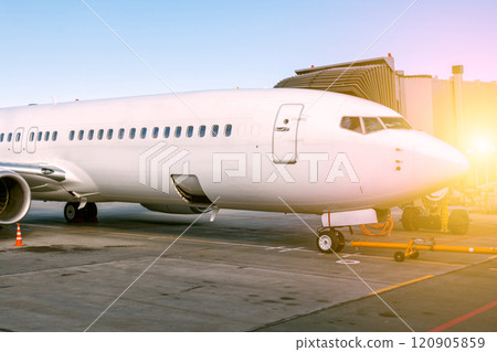 White passenger aircraft parked to a jetway 120905859