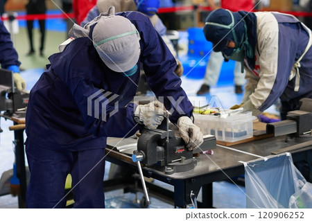 Technical intern trainee filing a file, deburring Technical intern trainee filing a file, deburring 120906252