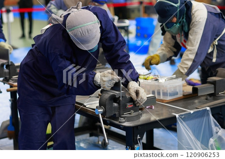 Technical intern trainee filing a file, deburring Technical intern trainee filing a file, deburring 120906253
