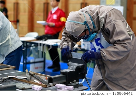 Technical intern trainee filing a file, deburring 120906441