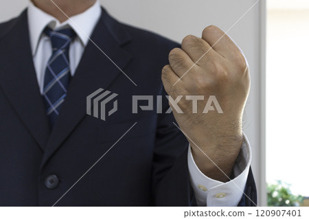 A man's hand in a suit clenching a fist (30s, Japanese) 120907401