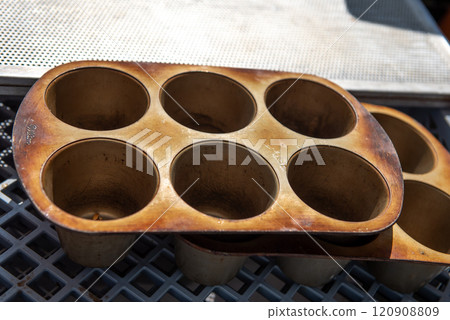 Top view of a metal muffin baking dish. Close up. cupcake molds on a baking sheet. Top view of a metal muffin baking dish. Close up. cupcake molds on a baking sheet. 120908809