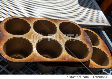 Top view of a metal muffin baking dish. Close up. cupcake molds on a baking sheet. 120908810