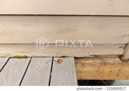 Wood Siding on House shows peeling and cracked painting and early signs of decay and rot Wood Siding on House shows peeling and cracked painting and early signs of decay and rot 120908817