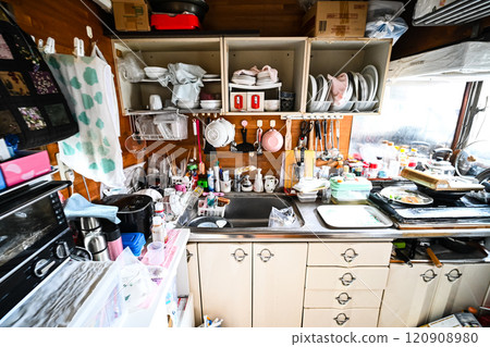A messy kitchen scene 120908980