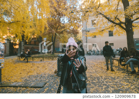 Experiencing the delightful Autumn Vibes in a Park filled with Colorful Leaves all around Experiencing the delightful Autumn Vibes in a Park filled with Colorful Leaves all around 120909678