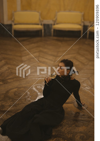 An Elegant Woman enjoys a drink in a beautiful classic setting, exuding charm and grace 120909896