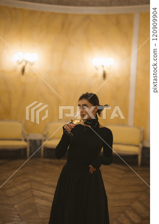 A Beautiful Woman in a Black Dress, Holding Champagne in a Luxurious, Classy Setting A Beautiful Woman in a Black Dress, Holding Champagne in a Luxurious, Classy Setting 120909904