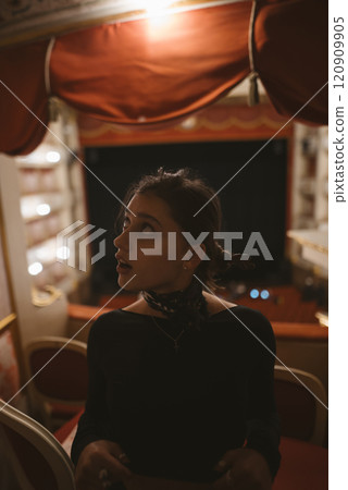 A Captivating Candid Moment in a Theater A Young Womans Evocative and Radiant Expression A Captivating Candid Moment in a Theater A Young Womans Evocative and Radiant Expression 120909905
