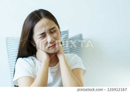 Unhappy - unwell Asian young woman having a mental health problem, woman feels uncomfortable after woke up from the bed. Young woman got a depression problem and mental burnout. 120912167
