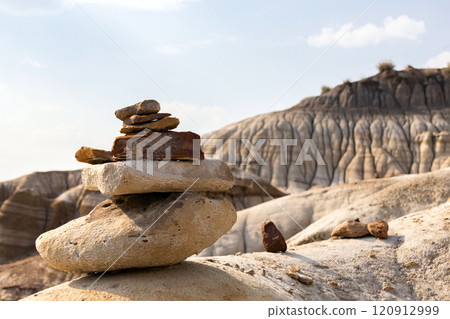 Stack of bright balancing rocks in badland canyon in summer. Stack of bright balancing rocks in badland canyon in summer. 120912999