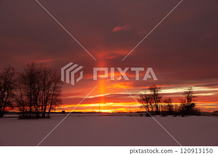 Pillar of orange light in prairies during sunset in winter. Pillar of orange light in prairies during sunset in winter. 120913150