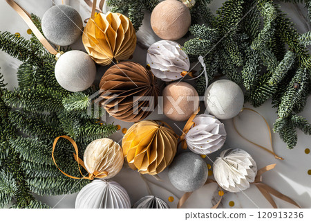 Christmas or New Year decorative background. Beautiful spruce branches, homemade paper origami balls Christmas or New Year decorative background. Beautiful spruce branches, homemade paper origami balls 120913236