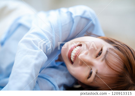 A young woman with a short bob lying on the floor A young woman with a short bob lying on the floor 120913315