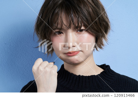 A young woman with short hair who looks angry 120913466