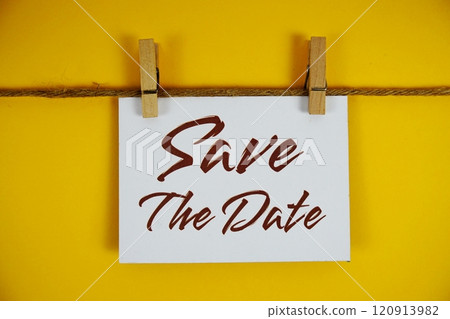 Save The Date text on paper card on yellow background Save The Date text on paper card on yellow background 120913982