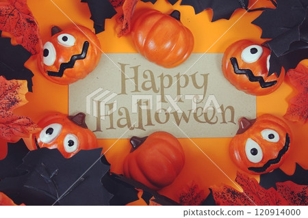 Happy Halloween text on paper with pumpkins decoration on orange background Happy Halloween text on paper with pumpkins decoration on orange background 120914000