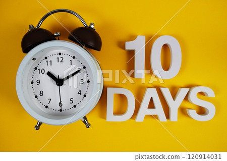 10 Days alphabet letters with alarm clock on yellow background 10 Days alphabet letters with alarm clock on yellow background 120914031