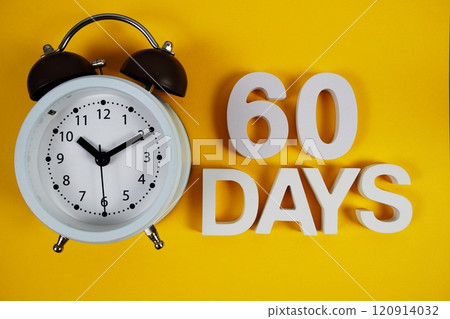 60 Days alphabet letters with alarm clock on yellow background 120914032
