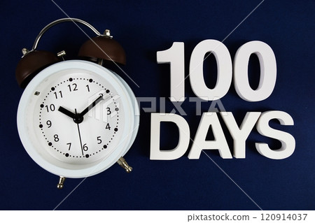 100 Days alphabet letters with alarm clock on navy blue background 120914037
