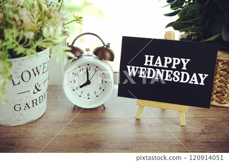 Happy Wednesday text on paper card with ealsel on wooden background Happy Wednesday text on paper card with ealsel on wooden background 120914051