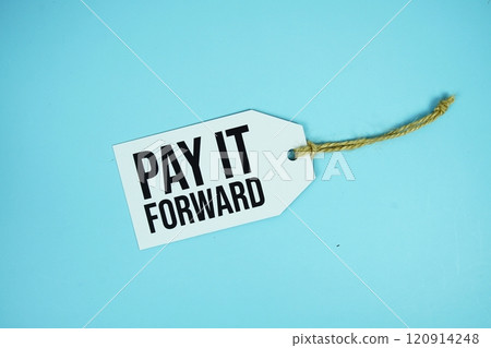 Pay It Forward text on price tage top view on blue background 120914248