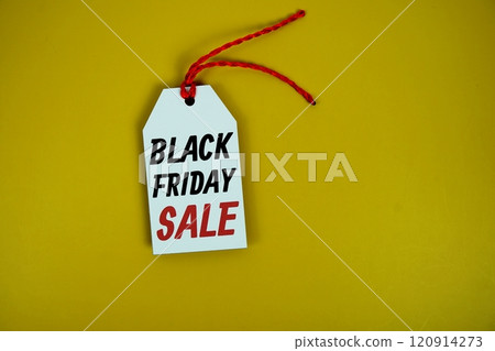 Black Friday Sale on price tag with wooden clothes hanger top view on yellow background Black Friday Sale on price tag with wooden clothes hanger top view on yellow background 120914273