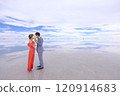 Uyuni Salt Flats | Romantic wedding photo of couples hiding their faces with bouquets of flowers and making love 120914683