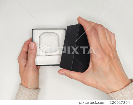 woman hand actively unboxing the latest wireless earbuds contain woman hand actively unboxing the latest wireless earbuds contain 120917204