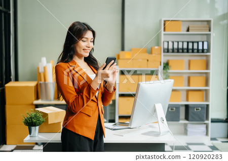 Startup small business SME, Entrepreneur owner woman using smartphone or tablet taking receive and checking 120920283