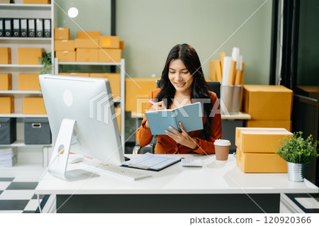 Woman Entrepreneur: SME Business mastering e-commerce with tablet, laptop, packaging, 120920366