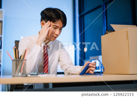 young  Asian man office worker celebrating her resignation, carrying her personal stuff. leaving job, changing or company 120922153