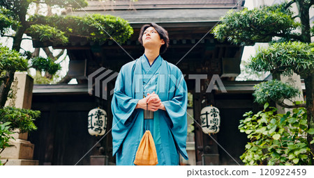 Kimono, thinking and low angle with Japanese man at temple for Shinto ceremony, fashion and prayer. Respect, travel and reflection with person in japan for traditional clothes, Buddhism and festival 120922459