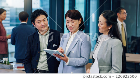 Business people, group and tablet at meeting, talking or networking at corporate conference in office. Woman, app and digital touchscreen for sign up at leadership workshop for career growth in Japan 120922500