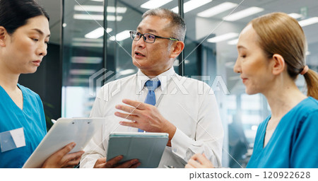 Doctor, nurse and tablet for healthcare, research and medical feedback with collaboration in hospital. Mature man, woman and planning for health report, teamwork or discussion with advice in Japan 120922628